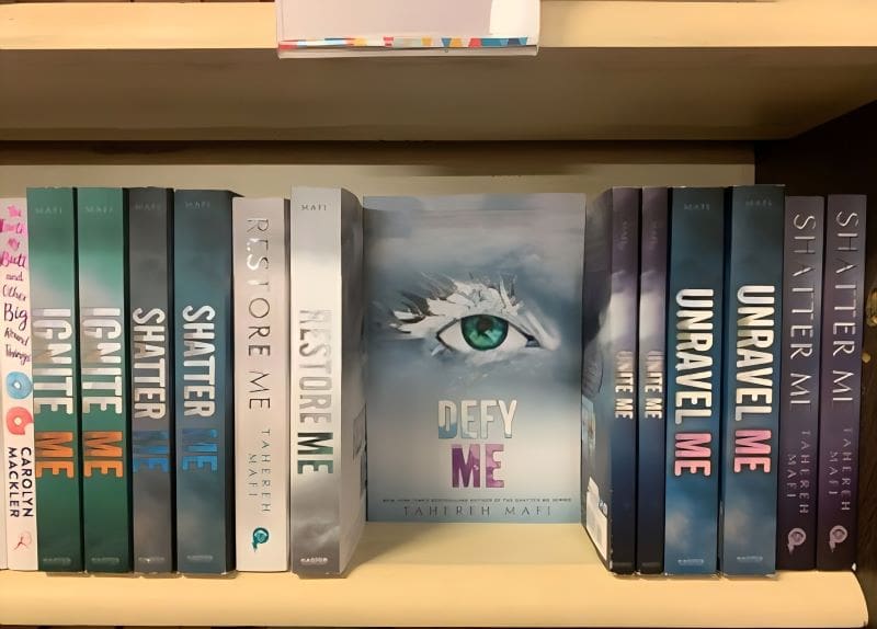 Row of Books by Tahereh Mafi with Defy Me in the Center